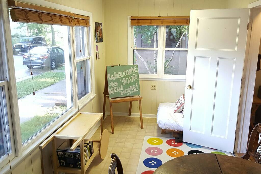 Three season sunroom welcomes natural sunlight from both the south and east to create a cozy space for lounging, eating, working, resting or all the above! Twin futon (pictured) offers additional sleeping space for guests.