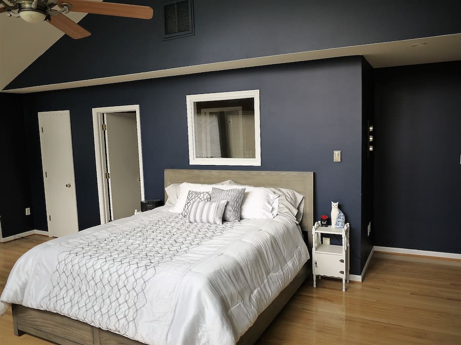 Large master bedroom with California king bed.