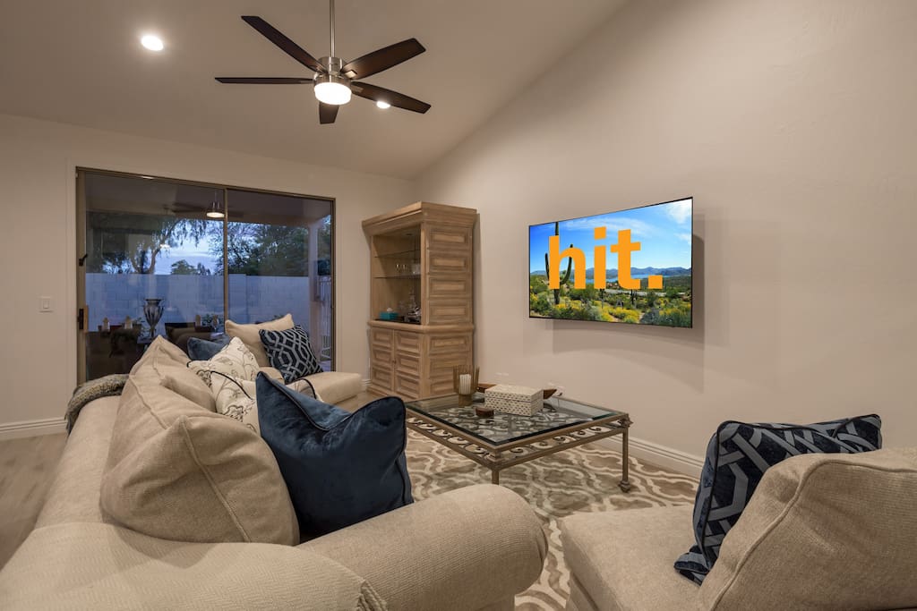 Living room with cush seating and curved 62" TV