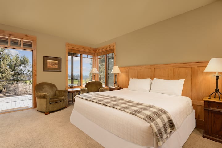 Bedroom 3 - Equipped with a plush king bed, closet for storage, workspace, a small seating area, flatscreen TV, kitchenette, an en-suite bathroom, and private entrance and patio access.