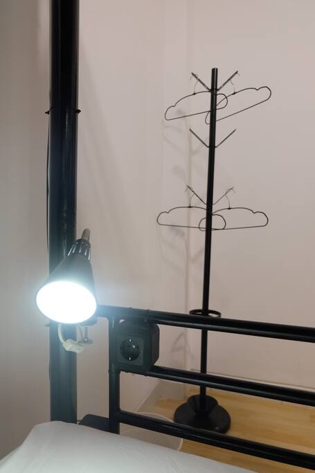 1 bed lamp and 1 plug each bed. Make sure you bring our own travel adapter.