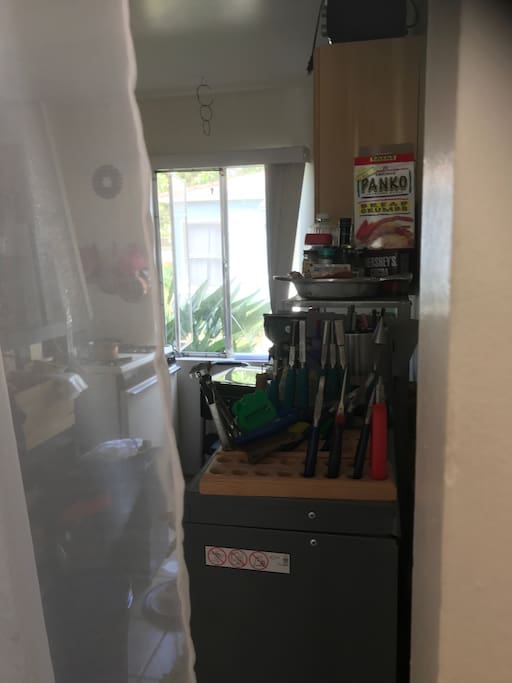 Kitchen - tools are kept in there as well behind curtain.
