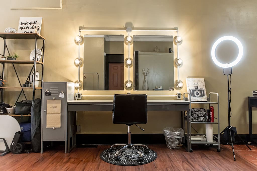 Hair and makeup vanity with multiple outlets, large counter top, and a ring light for makeup use.