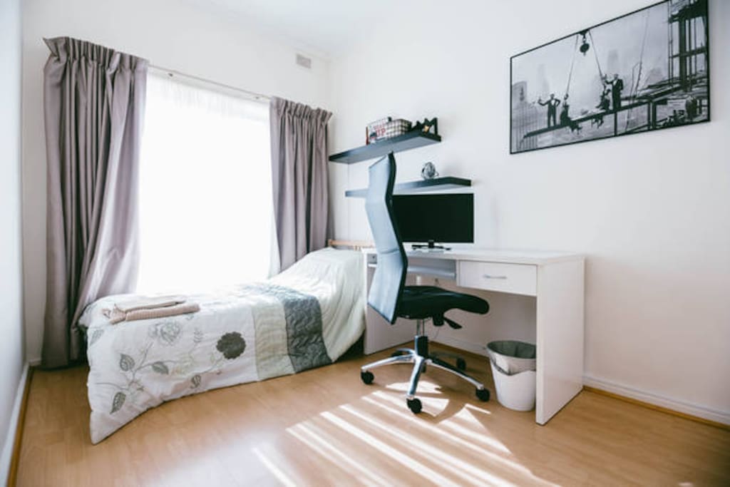 The single room with Bed, TV, desk and chair, cupboard etc