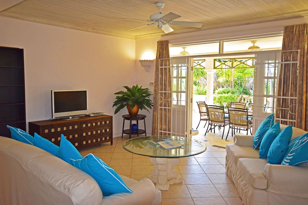 The comfortable 3-seater and 2-seater couch in the open-plan living area look out to the veranda and pool
