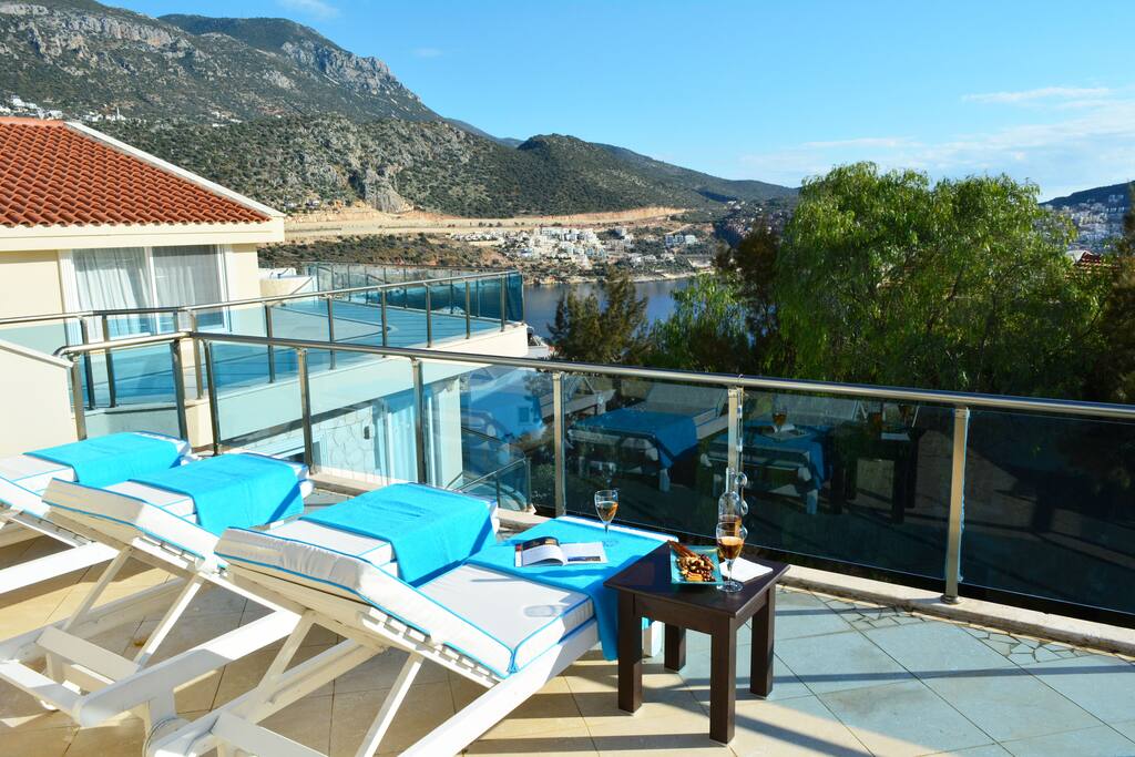 Private roof terrace furnished with sun-loungers and parasol