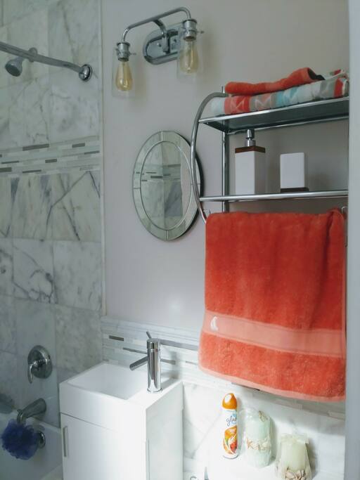 private bathroom with marble tile and all the modern essentials