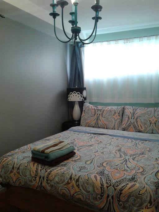 Queen size bed with foam mattress.