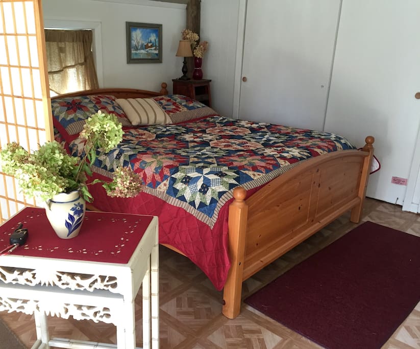 Knotty pine bed, linens provided with extra pillows and comfortable bedding