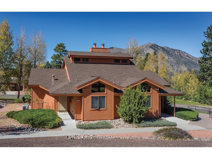 Exterior of a brown Airbnb in Flagstaff with mountain views