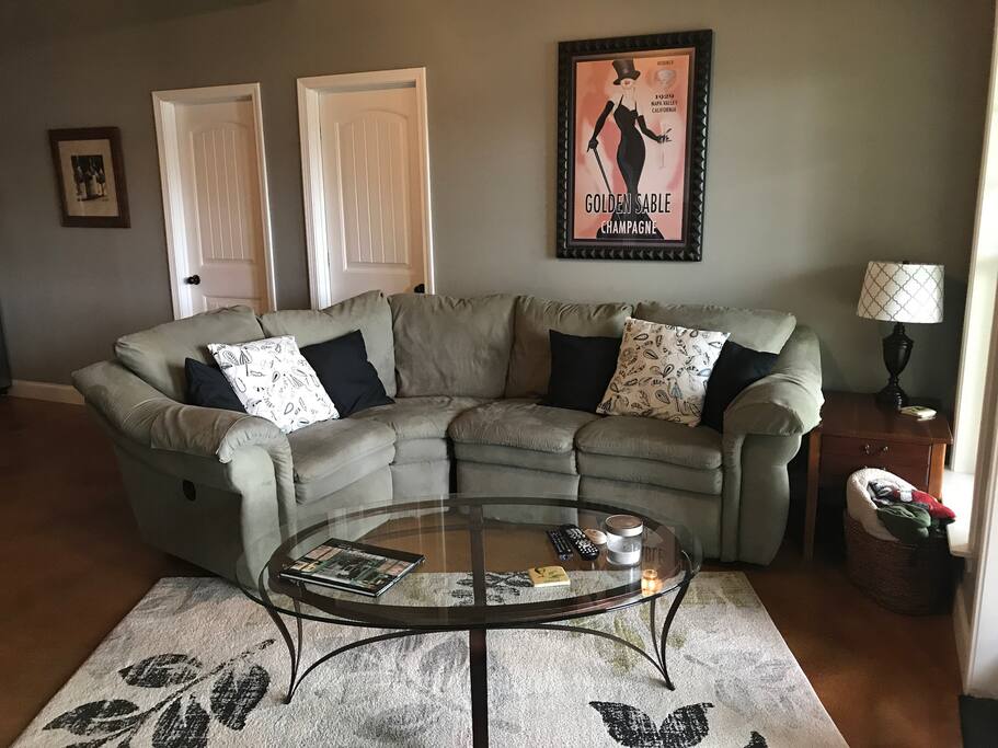 Living area, brand new sofa with 2 recliners, wood burning fireplace, and stunning lake view!