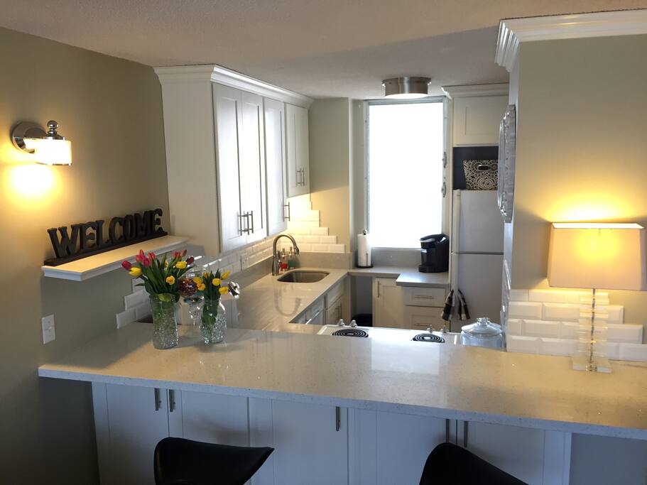 Counter and bar seating area with view to the living room