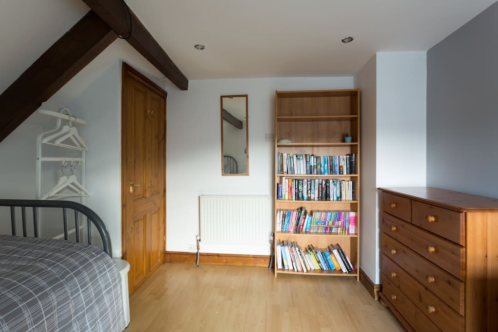 Large single bedroom on 2nd Floor showing hanging space, mirror, bookcase and drawers