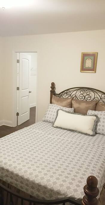 Bed + walk in closet. View from one corner
