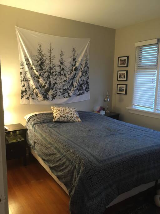 Private bedroom with queen bed, closet space, and two bed side tables with lights.