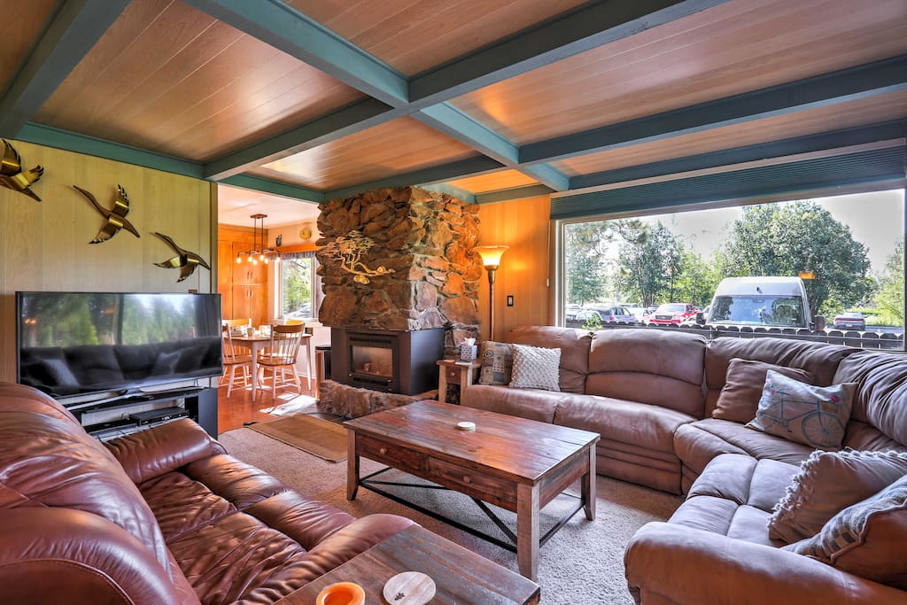 Lounge around the living room which features 2 plush couches, a gas-burning fireplace, and a flat-screen cable TV.