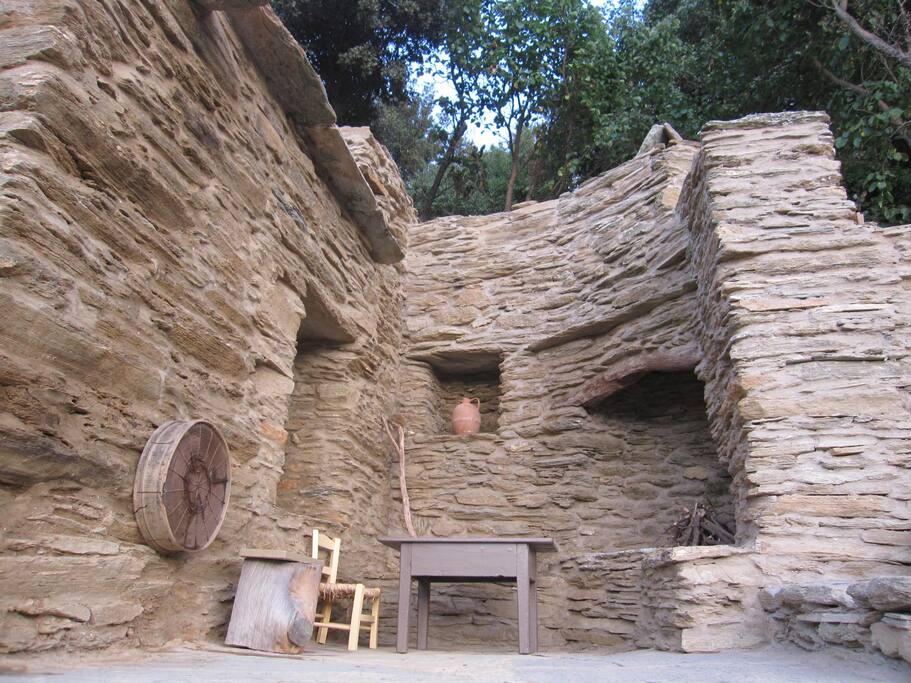 This outside eating area is to the right hand side of the house, with stone benches and the old fire place with a beautifully built cylindrical chimney.