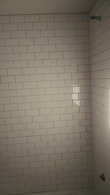 tiled bath for your bathing pleasure...curved rod for extra room