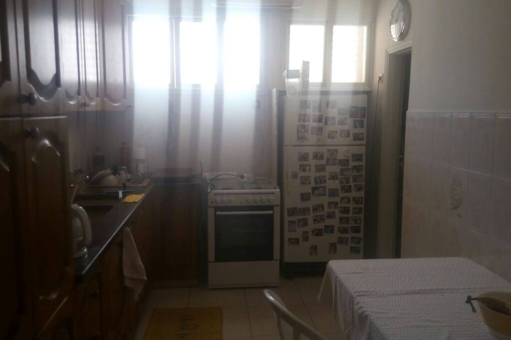 A large kosher kitchen equipped with a plate and a sitter for Shabbat. There are disposable utensils for use throughout the Passover holiday, dishes in the cupboards are not kosher for Passover