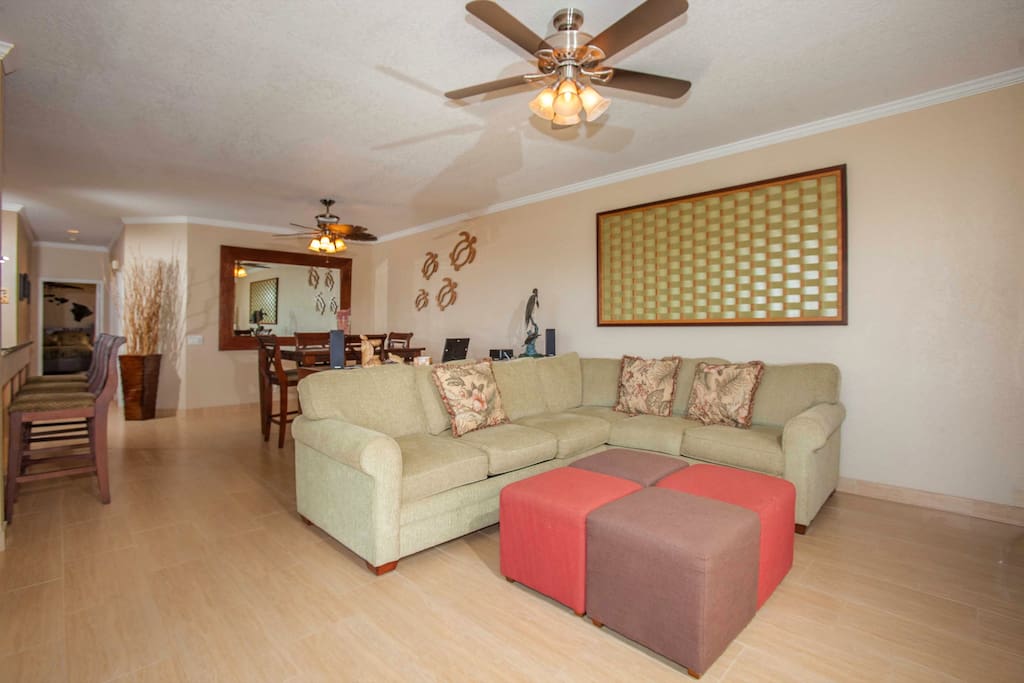 Large open floor plan with new sleeper sofa section and all one of a kind artwork.