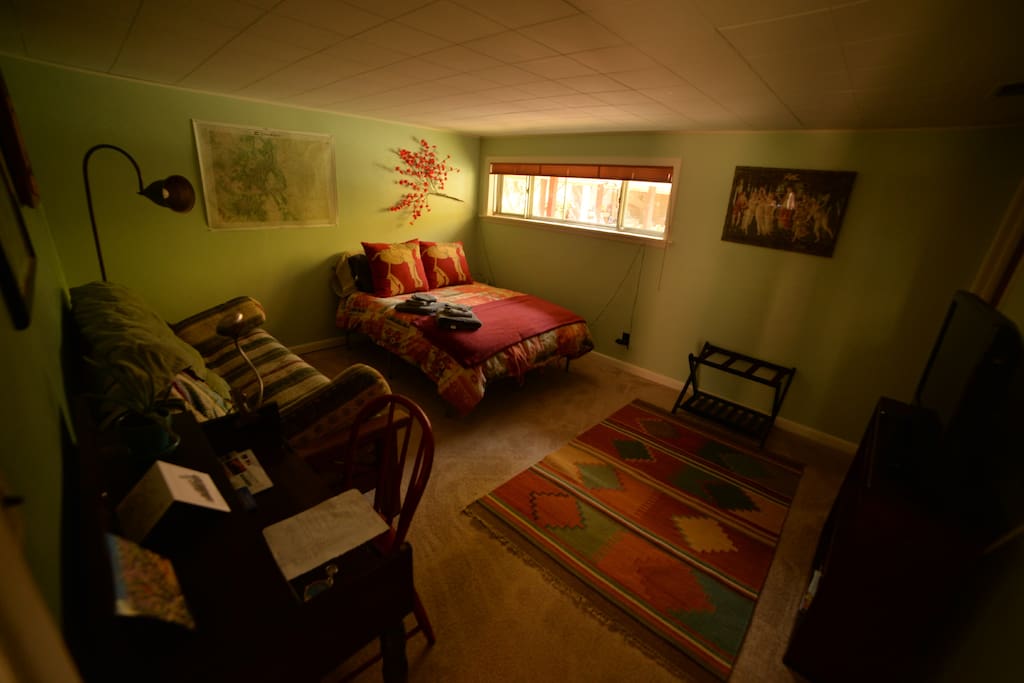 This bedroom is spacious and could sleep up to 4 people. That would certainly be cozy, but the futon does fold out to a full size bed.