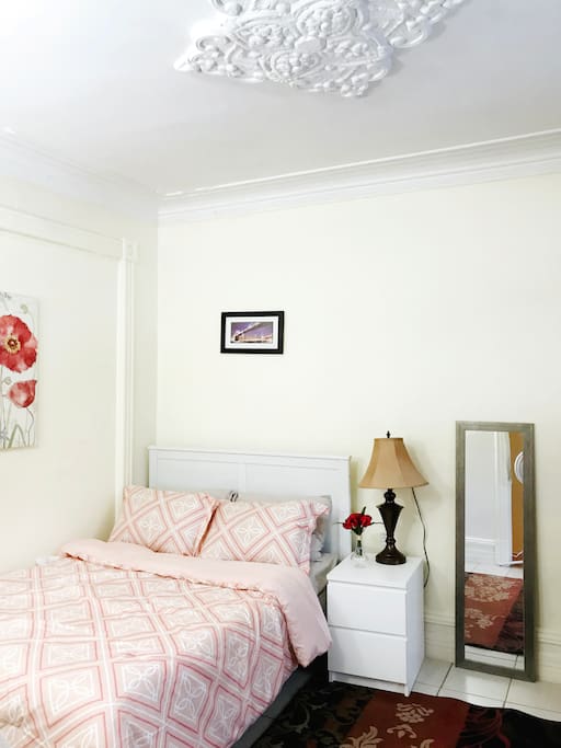 The larger room with a double bed and look at that beautiful crown moulding on the ceiling!