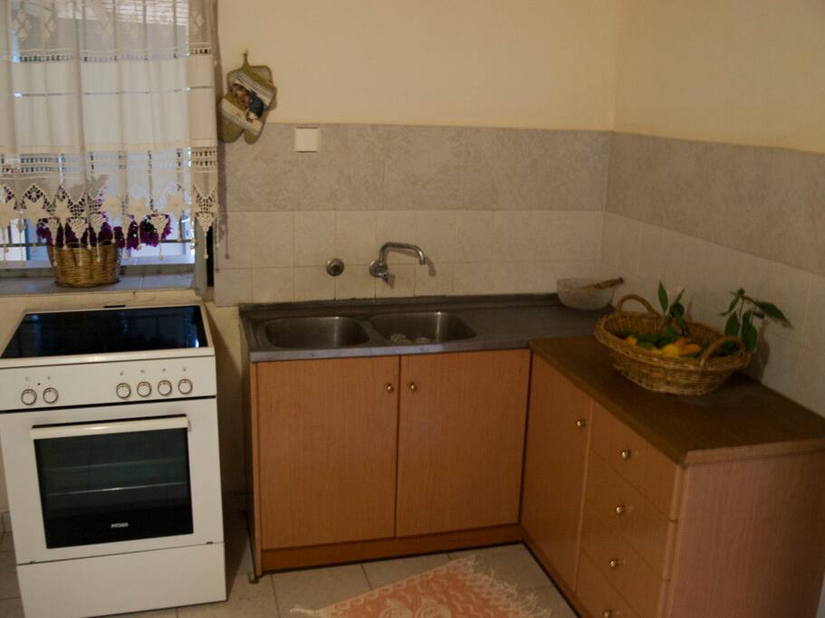 The kitchen across the double bed and sofa