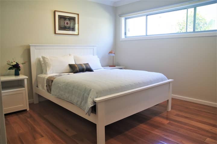 Bedroom is light and airy with quality linen on queen sized bed