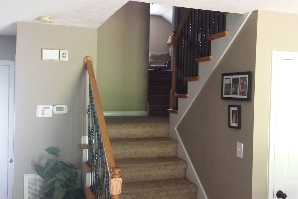 Stairs to bonus room and guest rooms and full bathroom