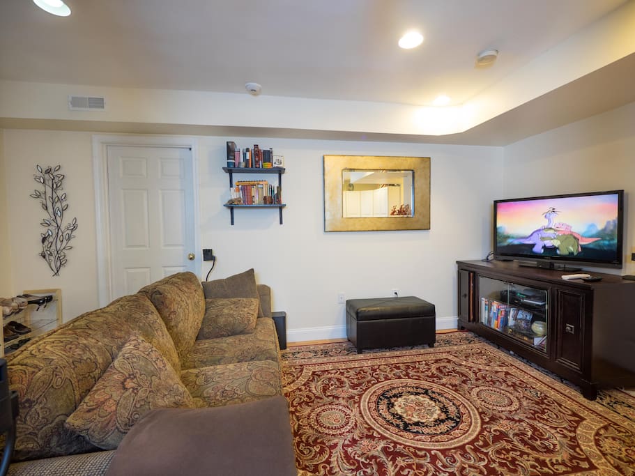 Living room with surround sound entertainment center and comfortable couch.