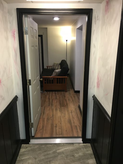 Standing outside the room with the door open looking in!