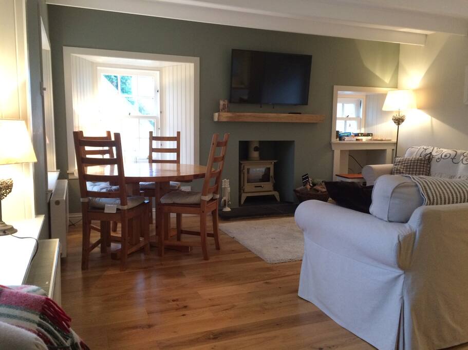 Living room with wood burner and 48" smart TV. Free Wifi