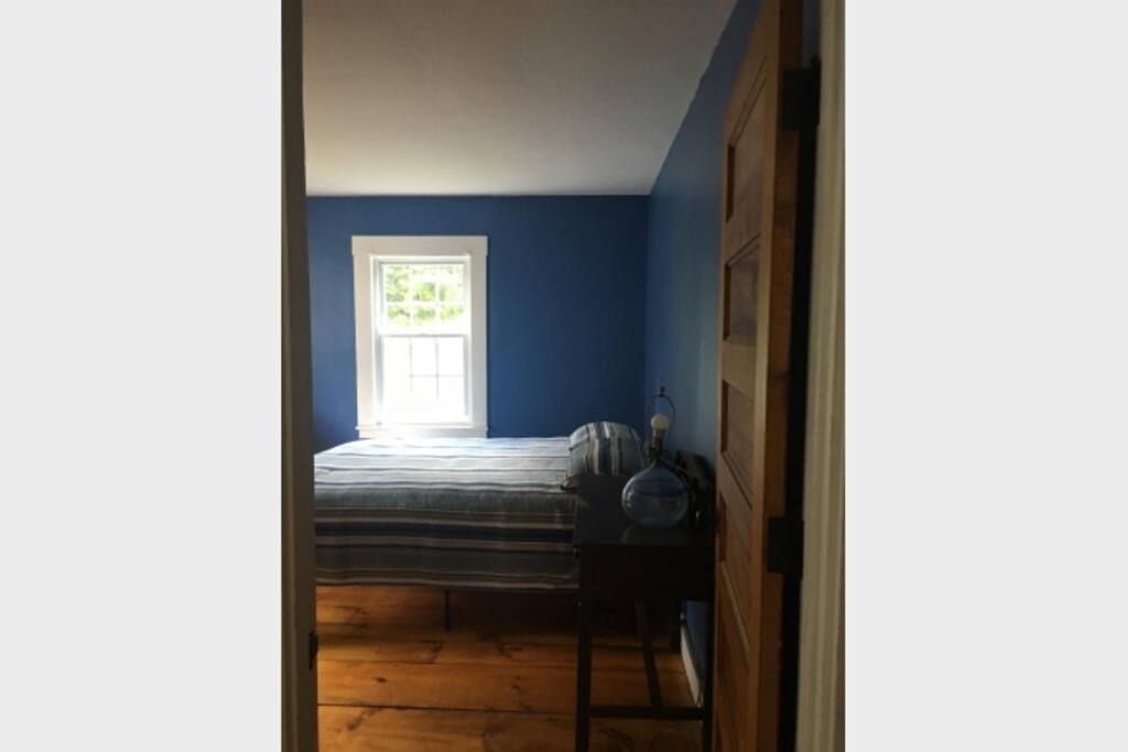 bedroom with a double bed, bureau and closet with games