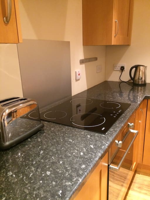 Newly installed kitchen with fridge, electric job and oven, kettle, toaster and cutlery and crockery. We have some provisions such as tea bags, coffee, sugar, oil, salt and pepper to get you started but there's a co-op nearby.