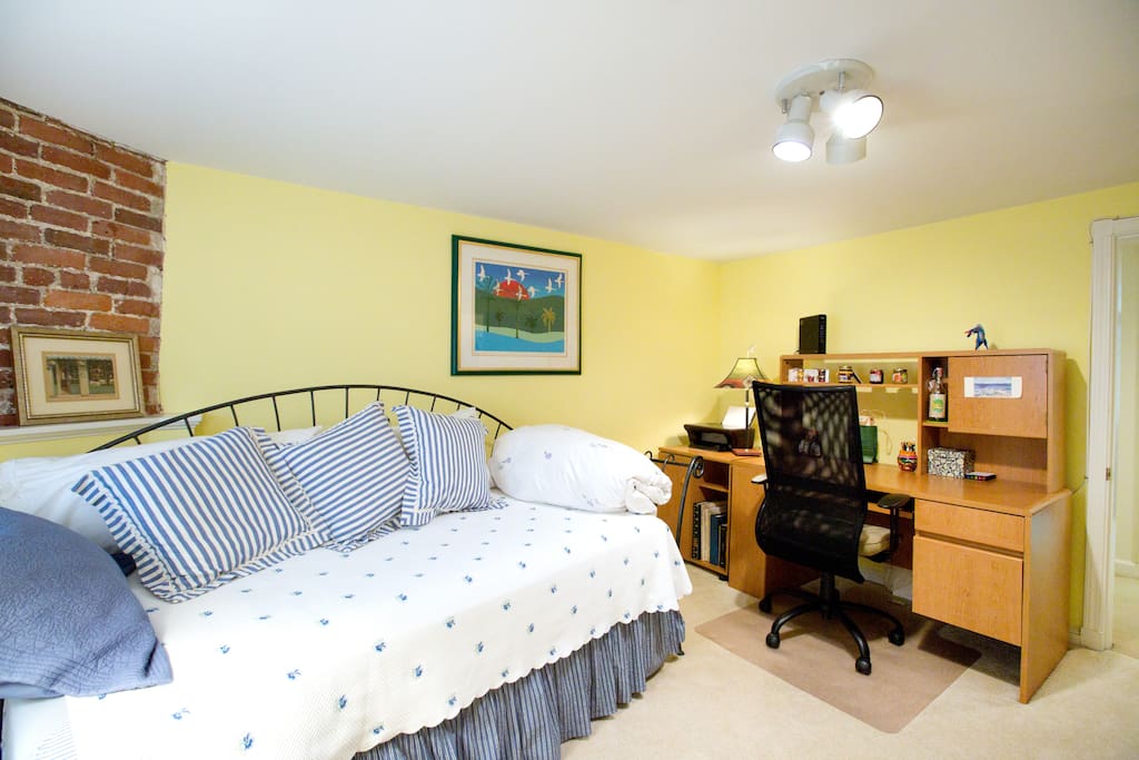 Desk in room with twin (trundle) beds