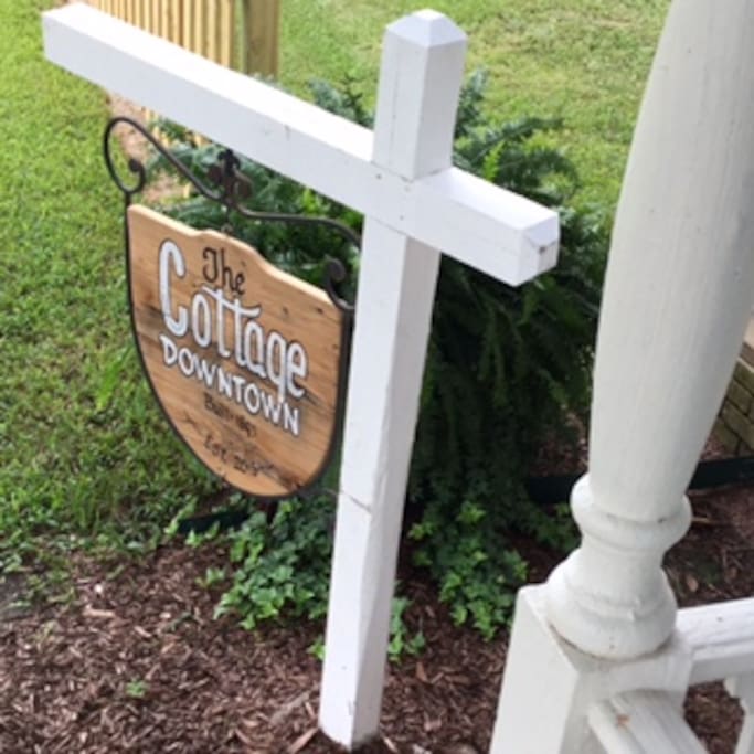 Local Artist DEMO painted this red cypress sign just for The Cottage Downtown! See all of his work all over Breaux Bridge!