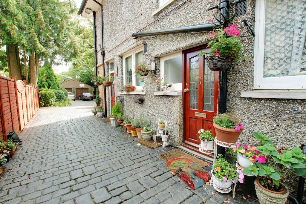 driveway leading to entrance for flat and back door to main house