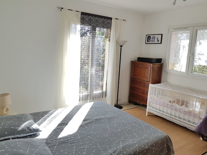 غرفة نوم بسرير كبير وسرير أطفال