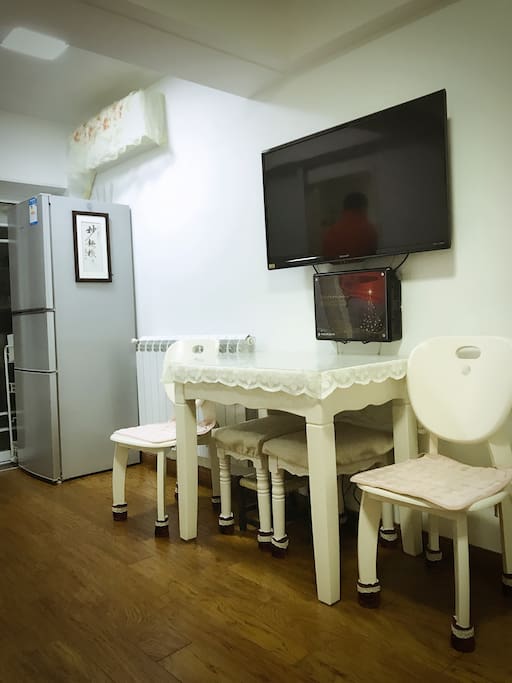 Dining area with cable TV, refrigerator and air conditioner.