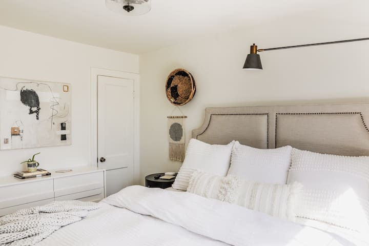 King bed with dual adjustable tempurpedic mattress and 55” Samsung television.