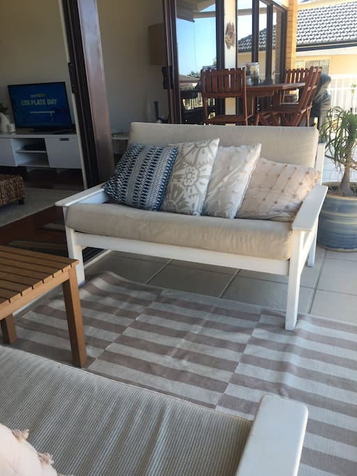 chill out on our screened balcony and listen to the waves .