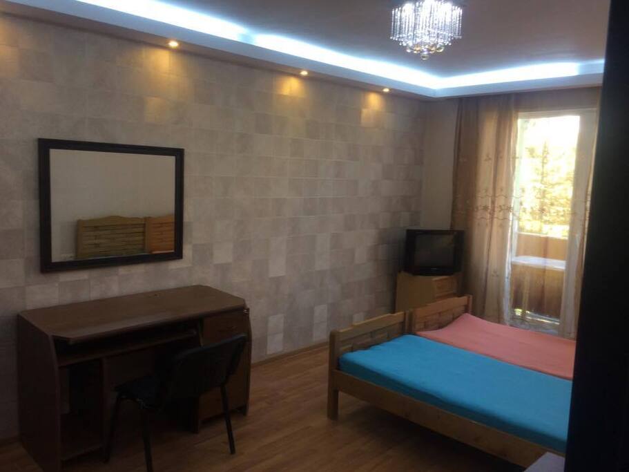 The bedroom with 2 beds, TV, dashboard and mirror