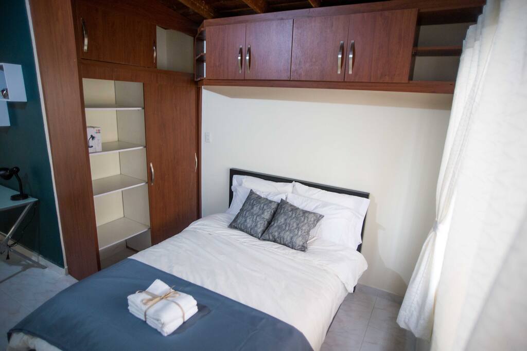 Another angle of the bed and shelving