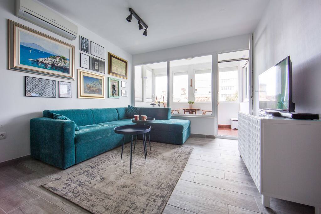 Living room - extendable sofa, coffee tables, tv and loggia behind