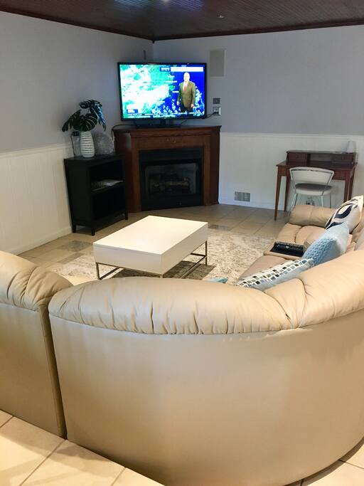 55” TV with cable sits atop a gas fireplace. A separate desk area is set up for any work you need to accomplish while staying.