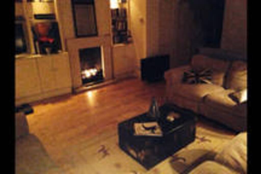 Large living room with fire place for those nasty rainy days