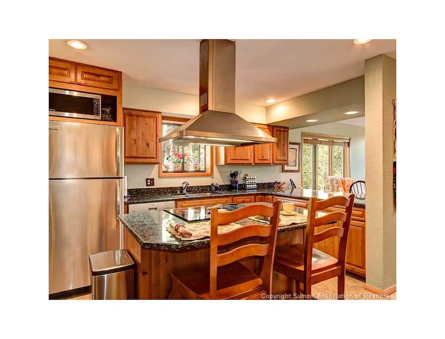 Remodeled kitchen with granite countertops.