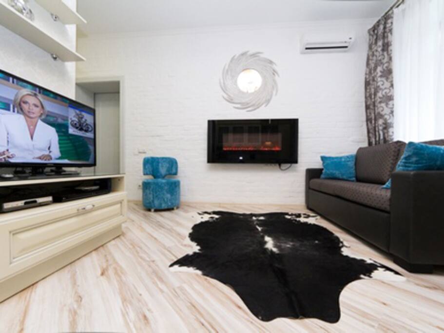Living-room with fire-place, open studio-kitchen