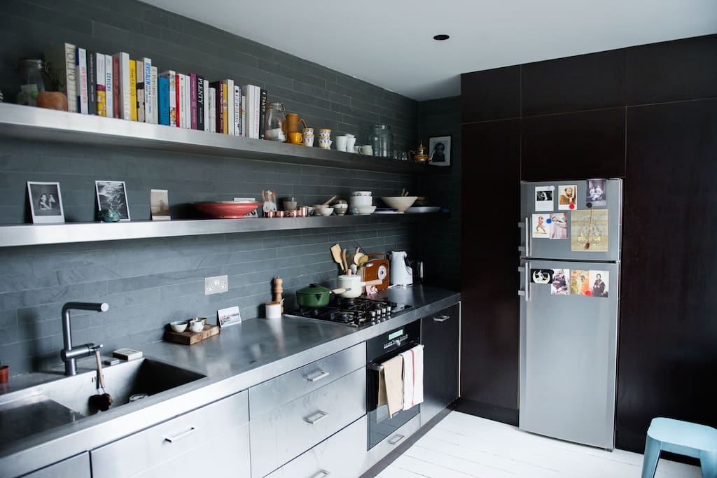 Cookbooks, stainless steel surfaces and breakfast stools.