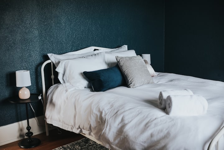 The upstairs bedroom has a queen sized memory foam mattress with an extra fluffy mattress topper and a large walk in closet.

Photo by @kailahomesphotography